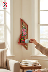 Real studio photograph with white background showing a handmade vertical wooden wall decor shelf featuring hand-painted pink roses and a red border.