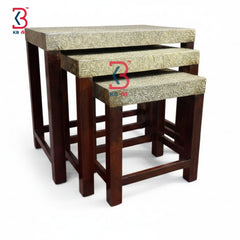 Set of three wooden tables with floral patterned tops on a white background