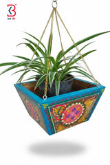 Decorative hanging planter with colorful design on a white background