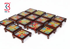 A set of small square wooden footstools or low tables with colorful mosaic tile tops, arranged on a plain white background. A KB Art logo is visible in the top-left corner.