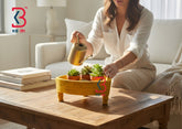 An AI-edited lifestyle scene displaying the yellow triangular wooden chakki used as an elevated riser for a decorative flower bowl in a living room.