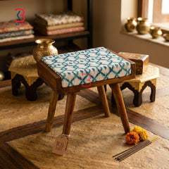 A modern room with a functional KB ART foldable stool used as a small decorative side table.