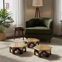 Hexagonal coffee tables in a living room setting with a green armchair and lamp.