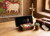 KB ART Hand Painted Wooden Mobile Stand Cow Art - Close-Up of Hand-Carved Artisan Texture - Handcrafted Wooden Decor Jodhpur