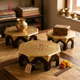 Decorative wooden tables with intricate carvings on a wooden surface.