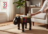 KB ART decorative hand-carved wooden elephant stool with an embossed golden brass sheet top, brass ears claddings, and dark wood legs on a clean white background.