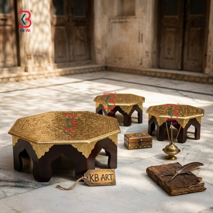 Decorative wooden brass tables with intricate designs on a stone floor.