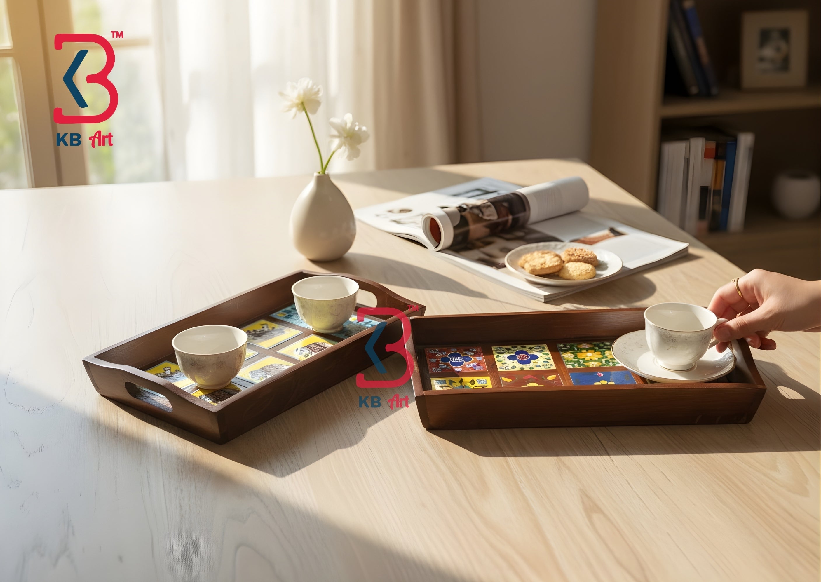 Two dark brown wooden serving trays with integrated handles, styled on a light wood table. One tray holds two small white teacups, and the other holds a white teacup and saucer while a hand is holding it.