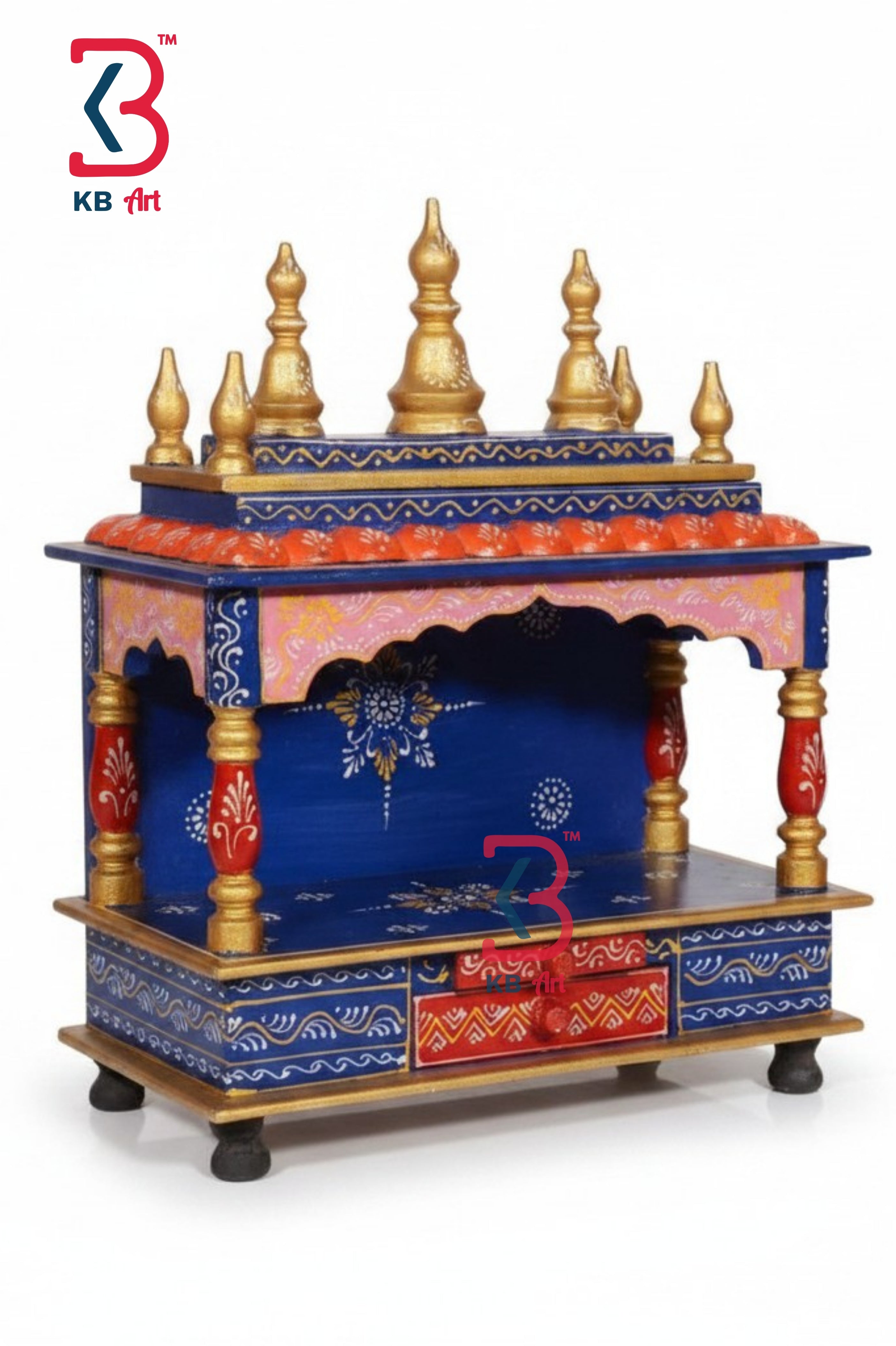 A hand-painted Indian miniature Hare Krishna gopuram (temple tower) with a blue and gold painted structure, featuring ornate gold finials, red and gold decorative panels, and a blue arched niche. The KB Art logo is visible in the top-left corner.