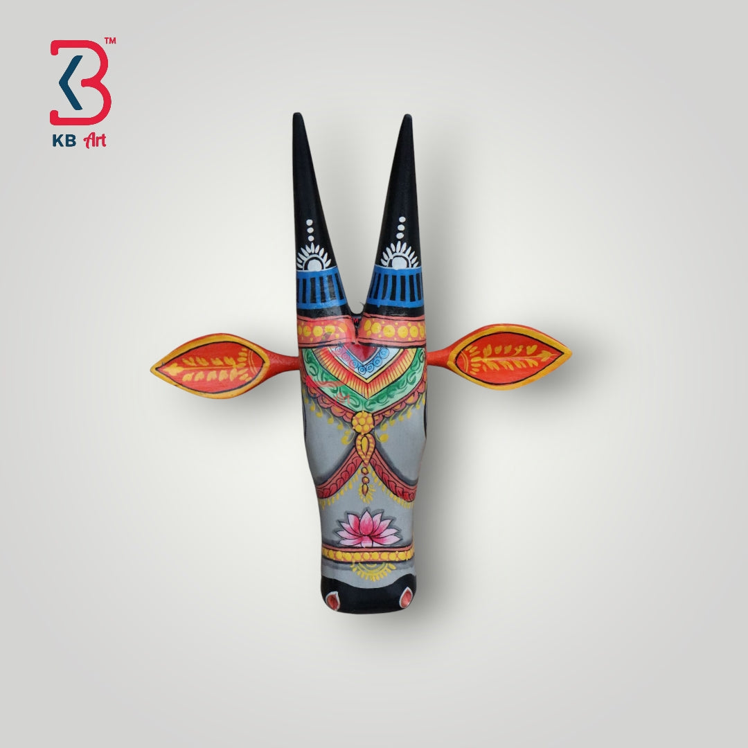 Hand-painted wooden cow head wall art with intricate designs and black horns.