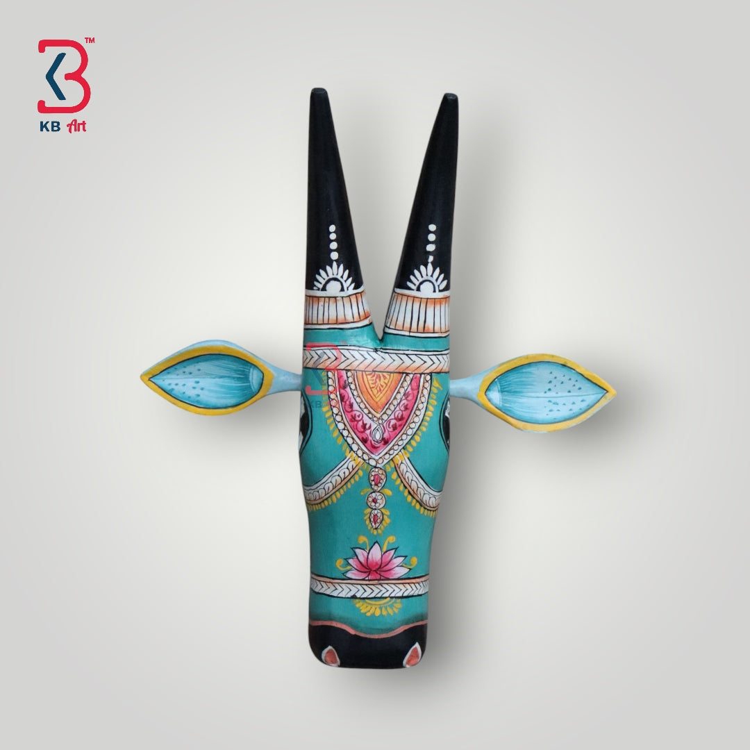 Hand-painted wooden cow head wall decor in turquoise with black horns and vibrant floral patterns.