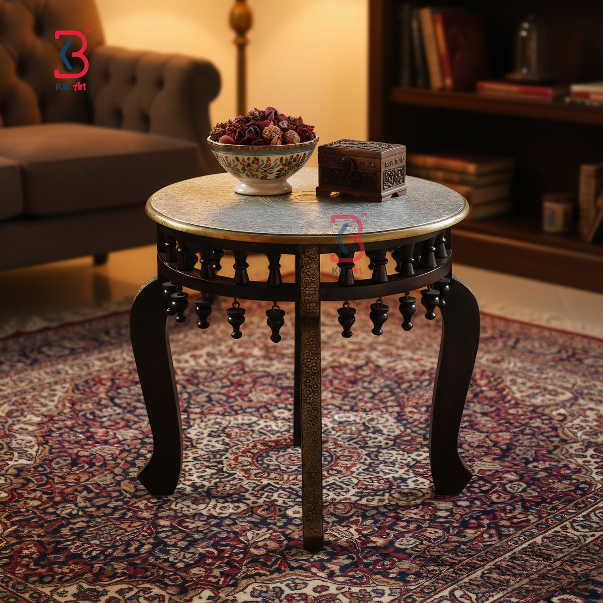 Decorative round table with a bowl and box on a patterned rug in a room.
