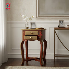 Wooden side table with gold accents in a room setting