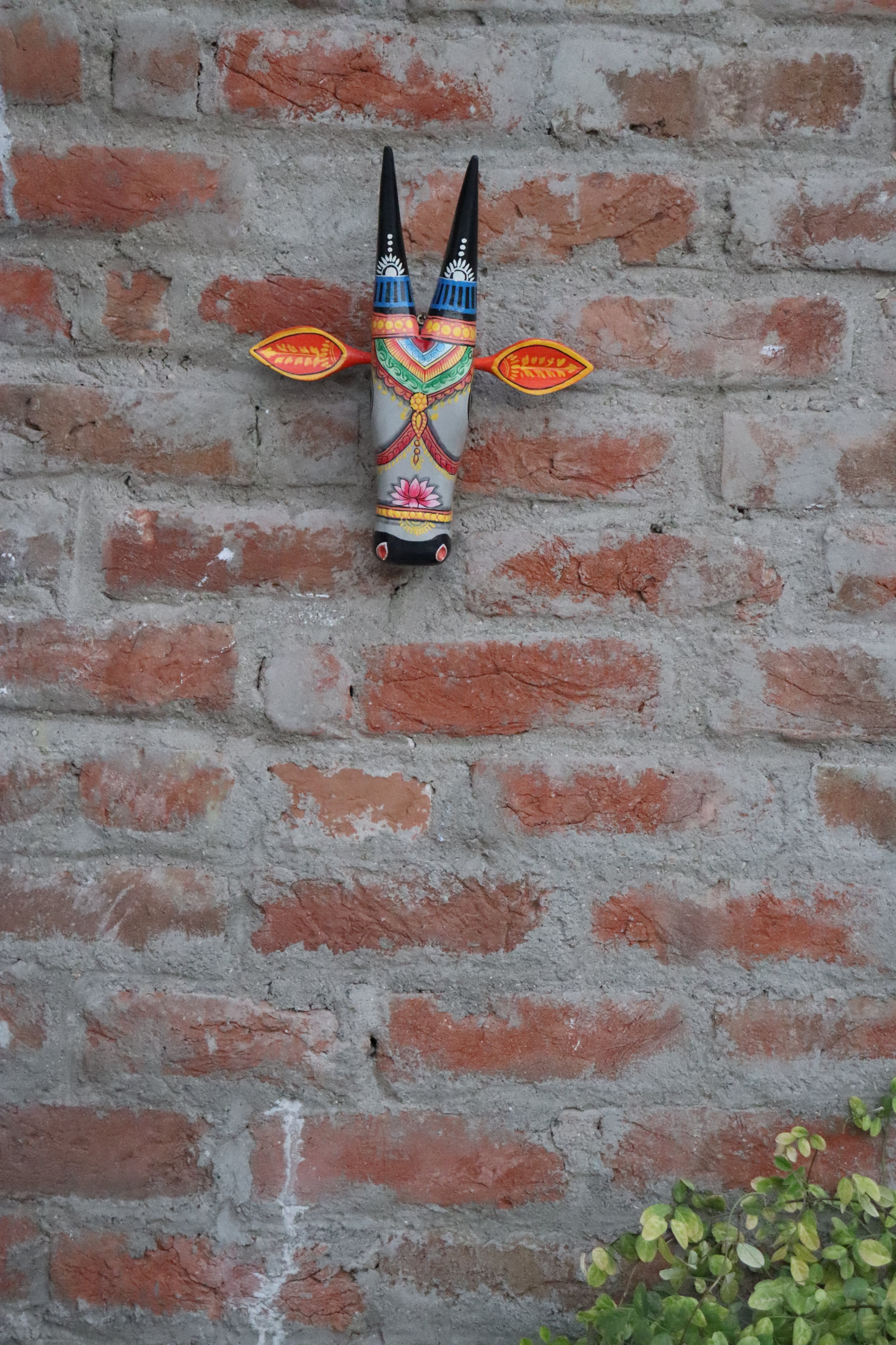 Decorative wooden cow head with sculpted horns and a beautifully hand-painted face, a perfect home accent.