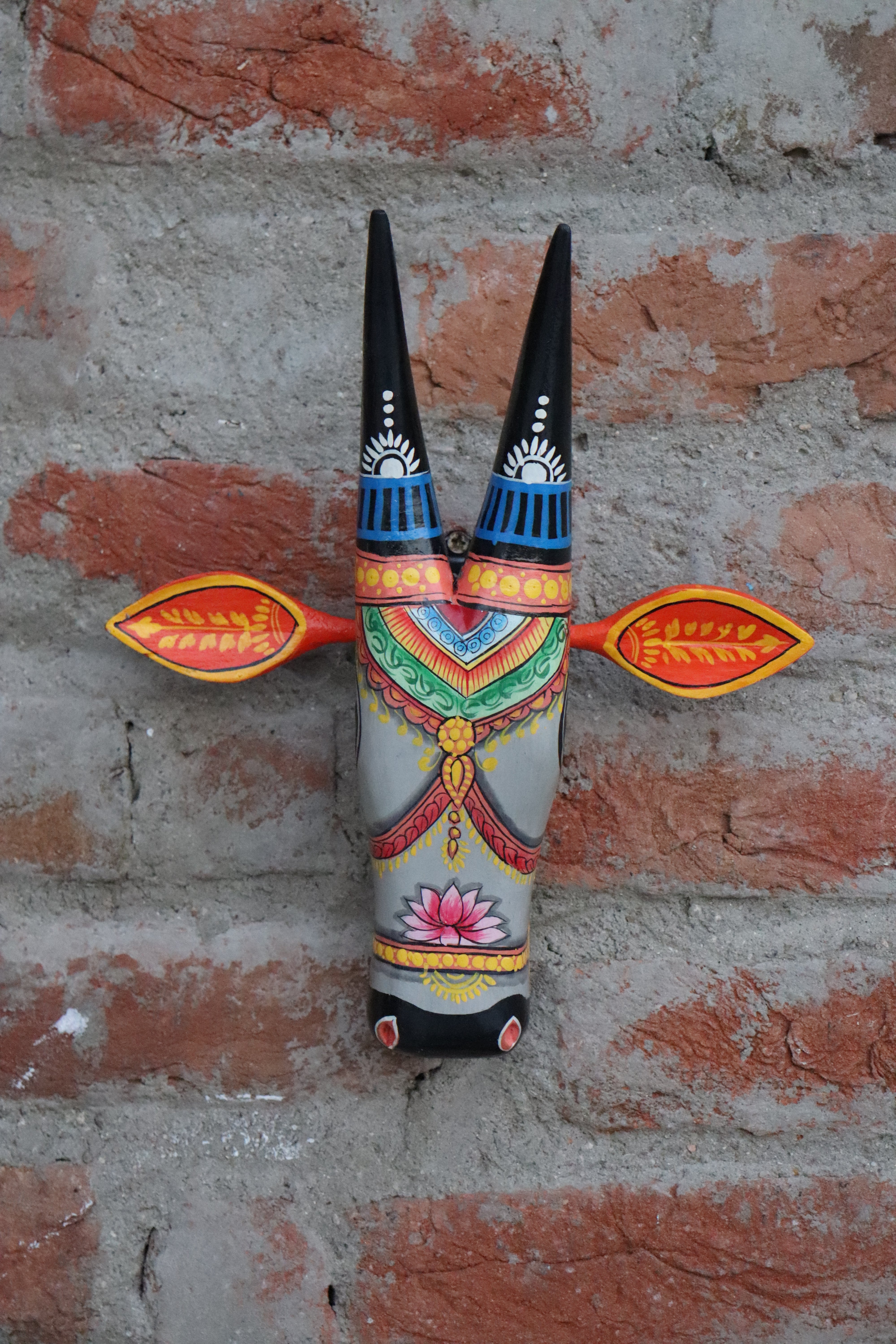 Traditional Indian folk art wooden bull bust, a colorful and unique piece for wall decoration.