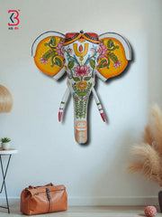 Artistic wooden elephant bust with vibrant, hand-painted details, perfect as an ethnic wall hanging.