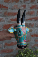 Ethnic carved wooden cow mask featuring a lotus flower motif and stylized ears for wall hanging