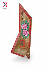 A styled lifestyle scene displaying the decorative hand-painted wooden shelf holding a green succulent pot.