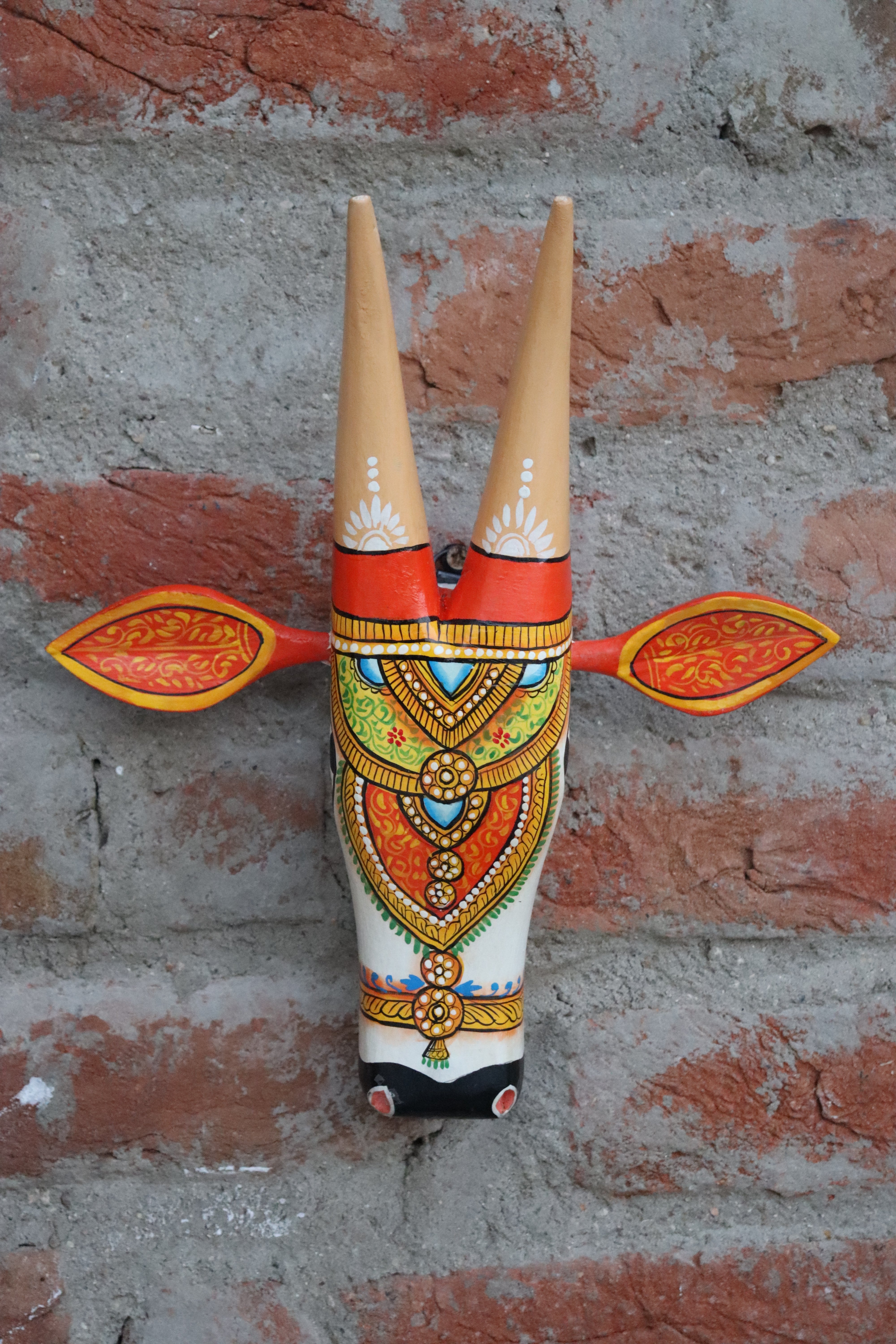 Traditional Indian cow head wall hanging with long horns and detailed decorative craftsmanship