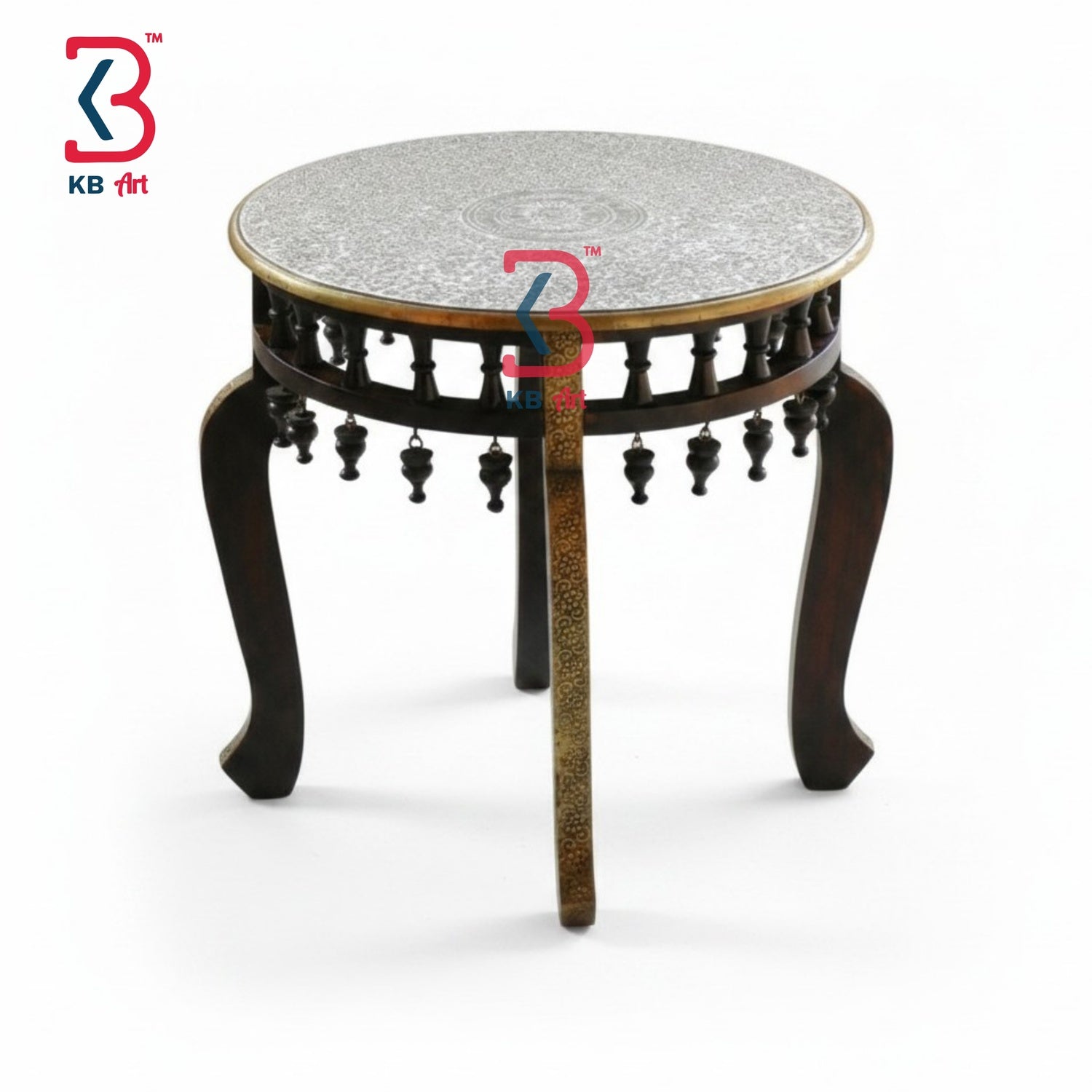 KB ART round carved brass fitted coffee table placed on a traditional red and blue oriental rug, holding a decorative colorful bowl of potpourri and a vintage wooden box.