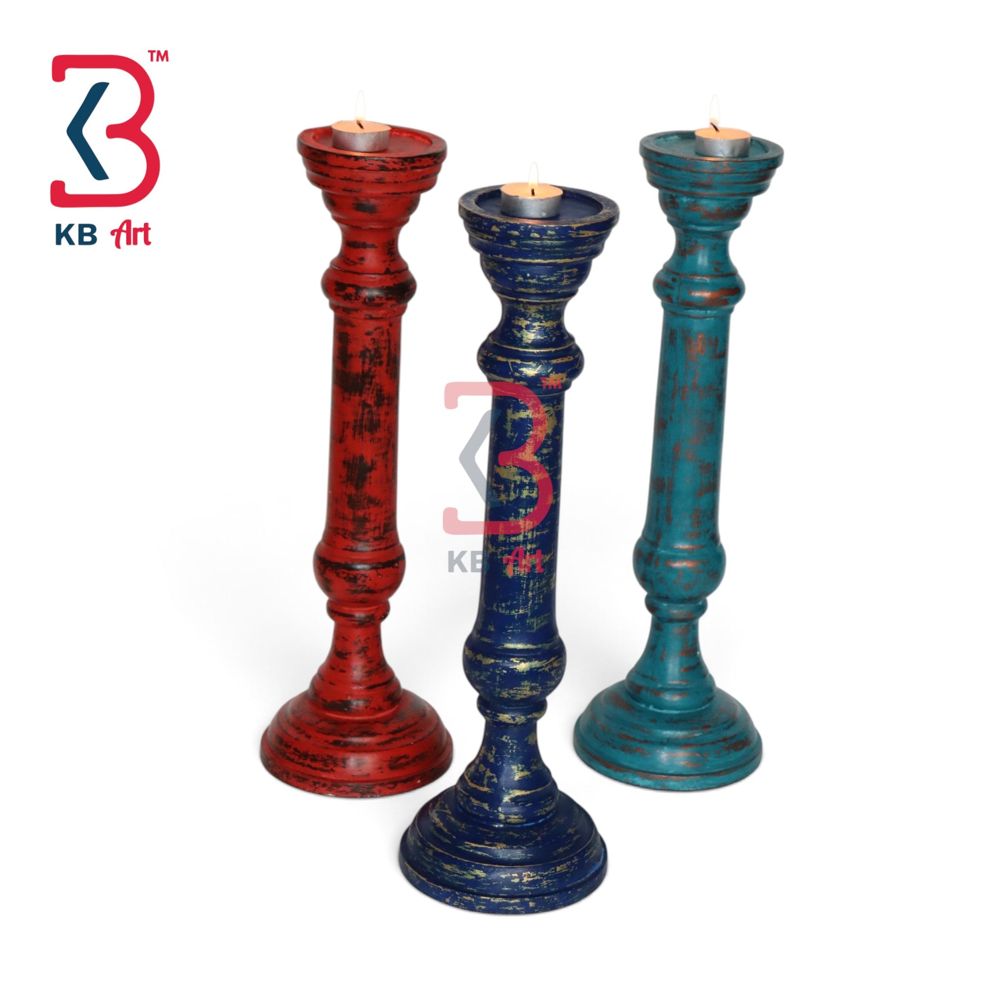 Three distressed wooden candlesticks in red, blue, and teal, each holding a tealight candle, displayed on a white background with a KB Art logo in the top left.