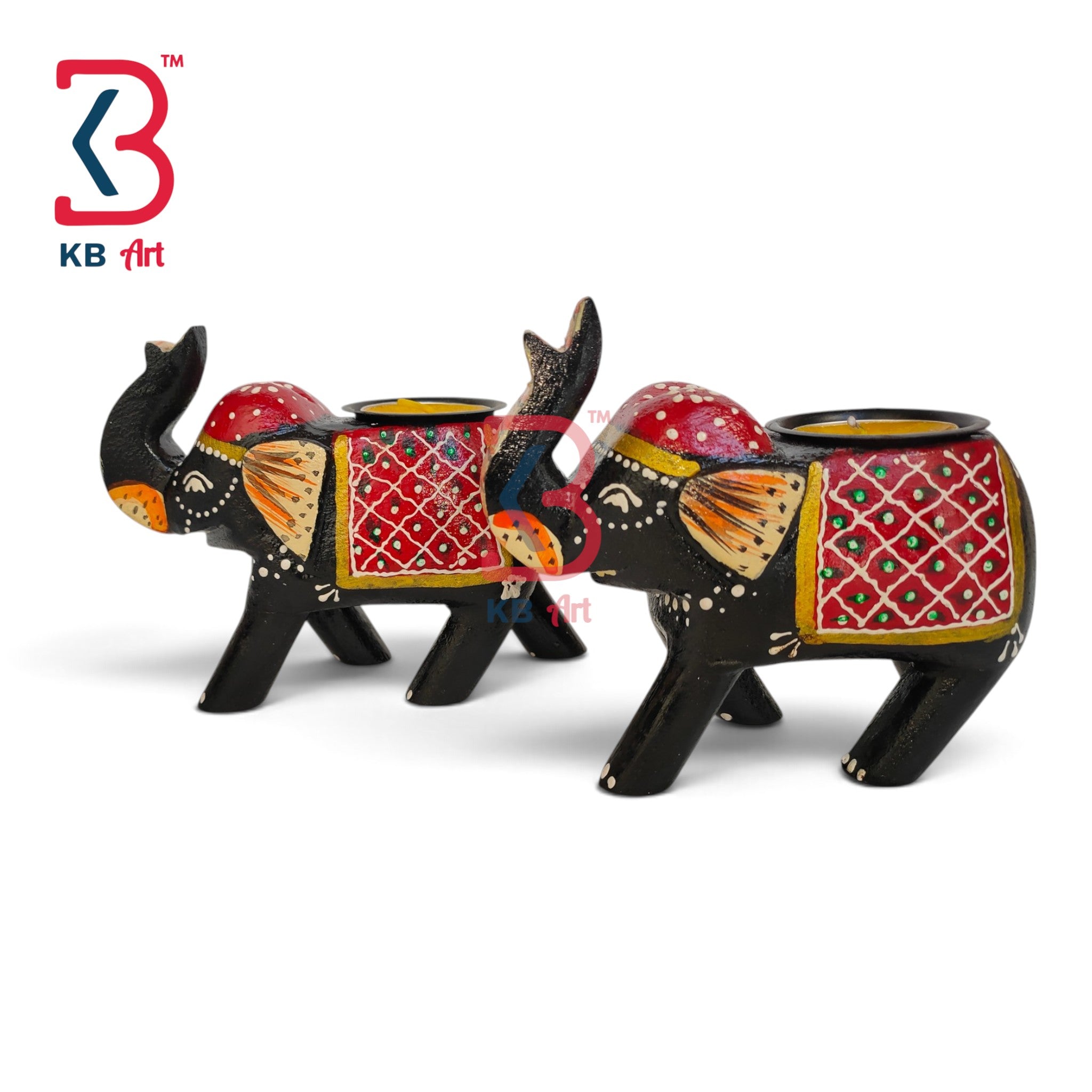 Two decorative elephant-shaped candle holders with black bodies and red, gold, and orange painted details, shown on a white background. A KB Art logo is visible in the top left corner.