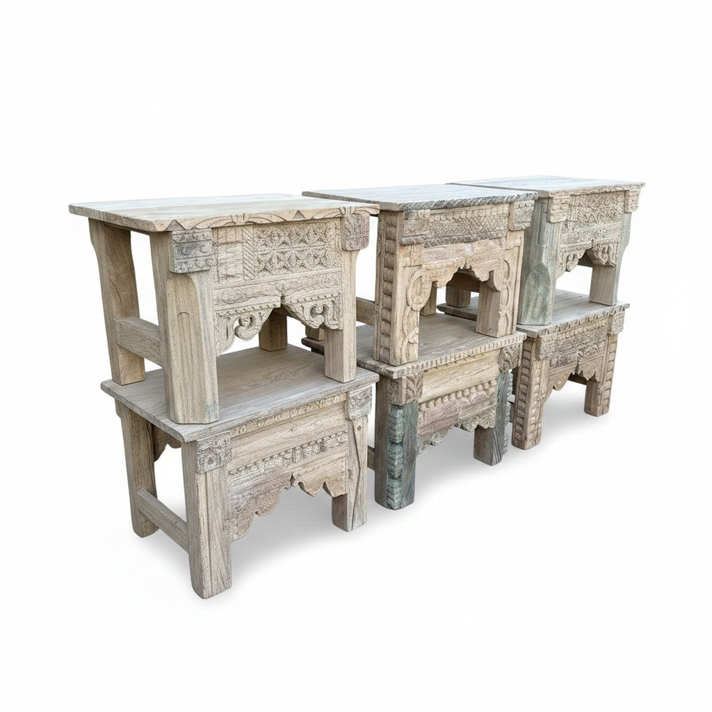 Set of four carved wooden side tables with distressed whitewash finish, featuring intricate traditional patterns and open shelving, photographed on a white background.