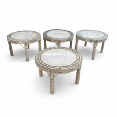 Four round wooden tables with distressed light gray painted finishes, arranged on a clean white background.