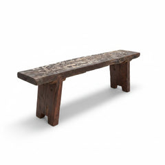 A rustic dark brown wooden bench with a heavily textured, weathered top and thick block-style legs, shown on a clean white background.