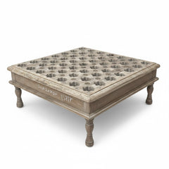 A square wooden coffee table with a distressed gray-brown finish, featuring a grid of cup holders on the top surface and turned legs.