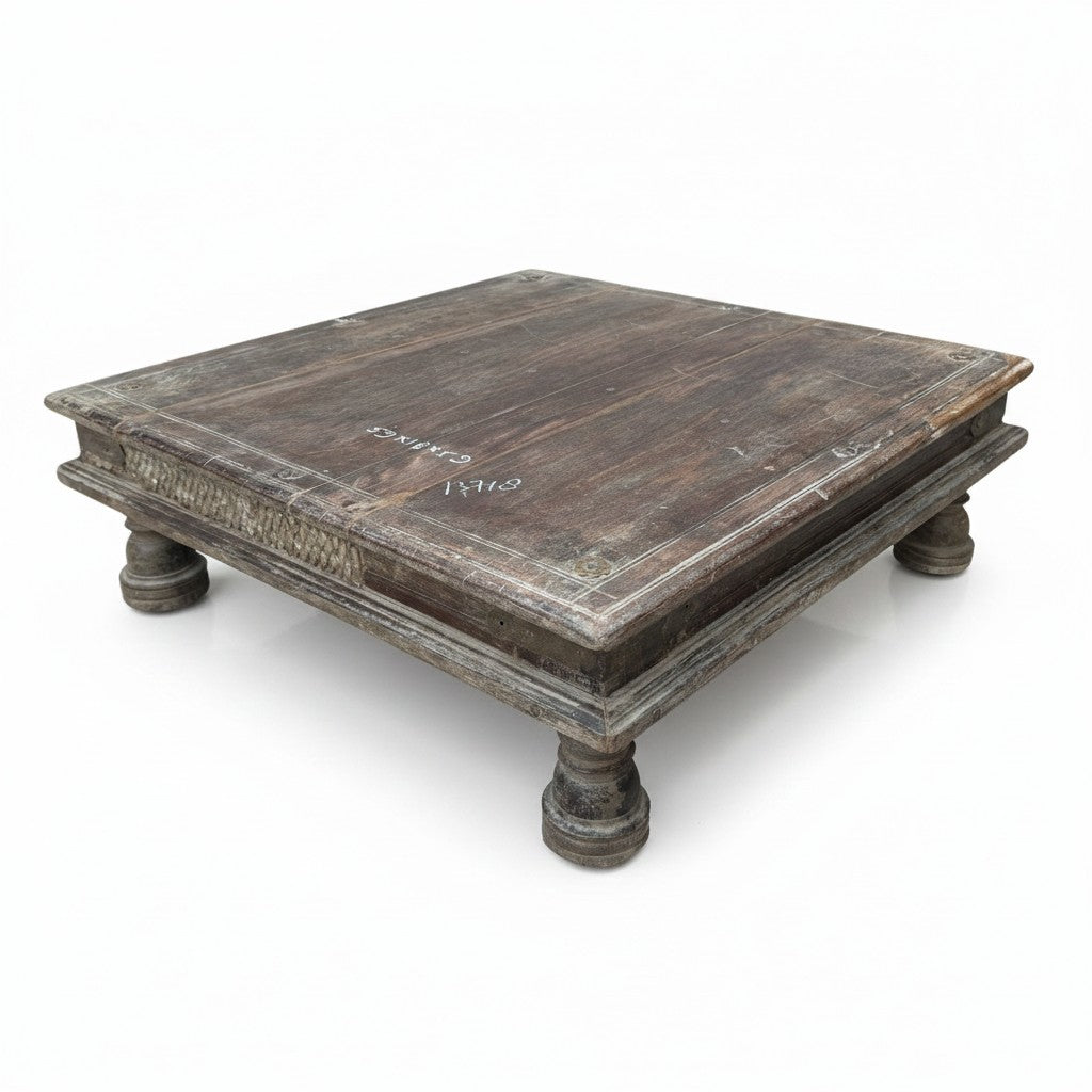 A square, low wooden coffee table with a distressed dark brown finish and turned legs, photographed on a white background.