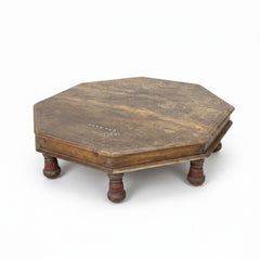 An octagonal wooden platform or low table with four turned legs, shown on a plain white background.