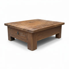 A square wooden coffee table with a single drawer on the front, featuring a medium brown wood finish and a small metal pull handle, shown on a white background.