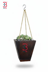 Hanging planter with a logo on a white background