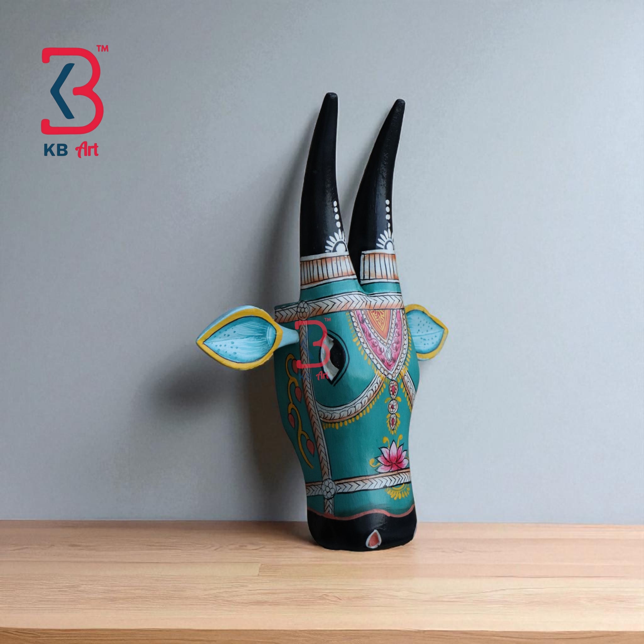 Decorative wooden bull head with a striking turquoise and black color scheme, perfect for a statement piece.