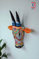 Artistic wooden bull head sculpture, perfect for cultural or bohemian home decor.