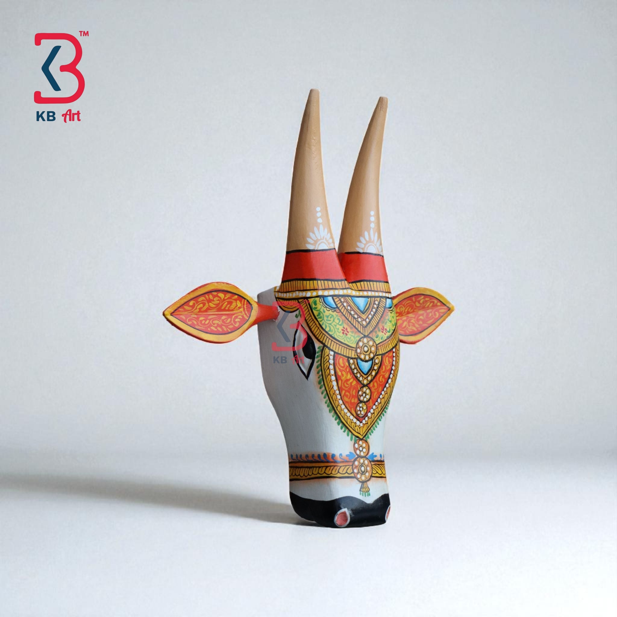 Colorful Indian folk art cow head, a unique piece for rustic or farmhouse-style interiors.