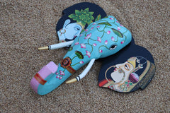 Artistic wooden elephant wall decor featuring painted depictions of a Radha and Krishna on the ears.