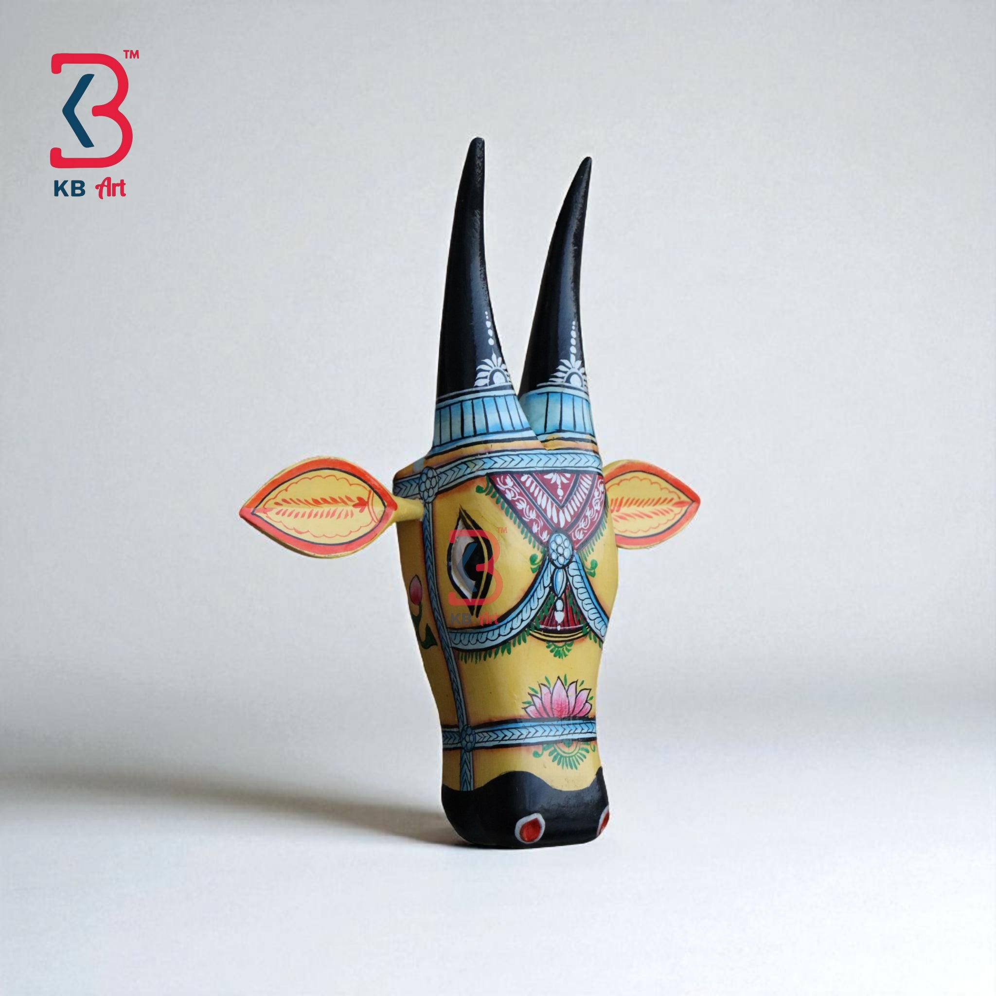 Handmade wooden cow head decor with bold colors and unique patterns, ideal for a gallery wall.
