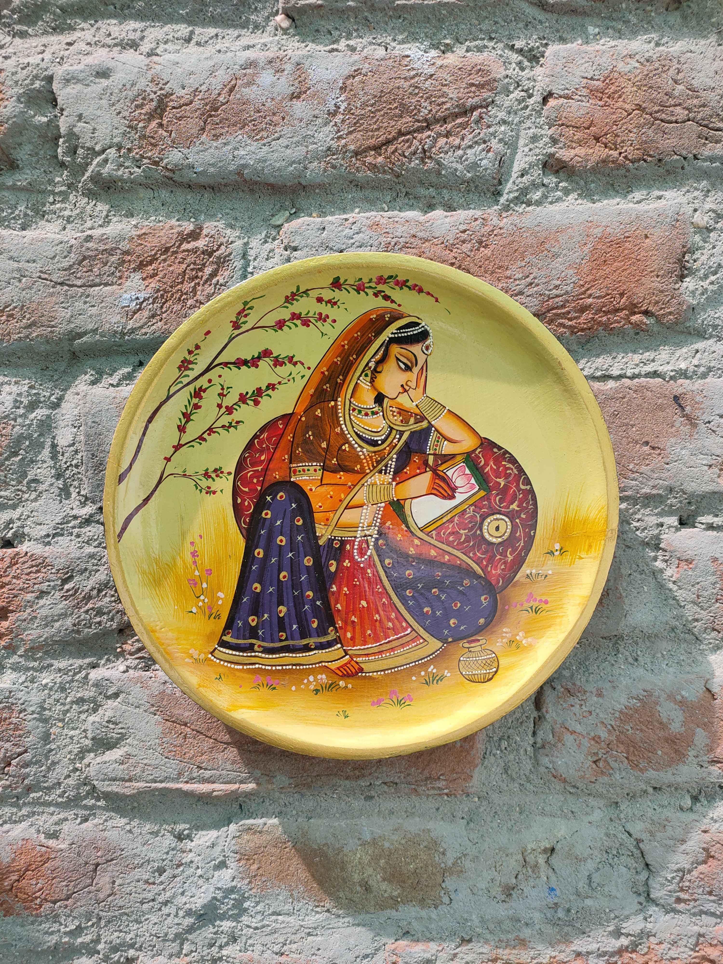 KB ART 12x12 Inch Round Handpainted Wooden Pichwai Wall Plate  – Traditional Rajasthani Lady Writing on Book – Cream Base Wall Decor