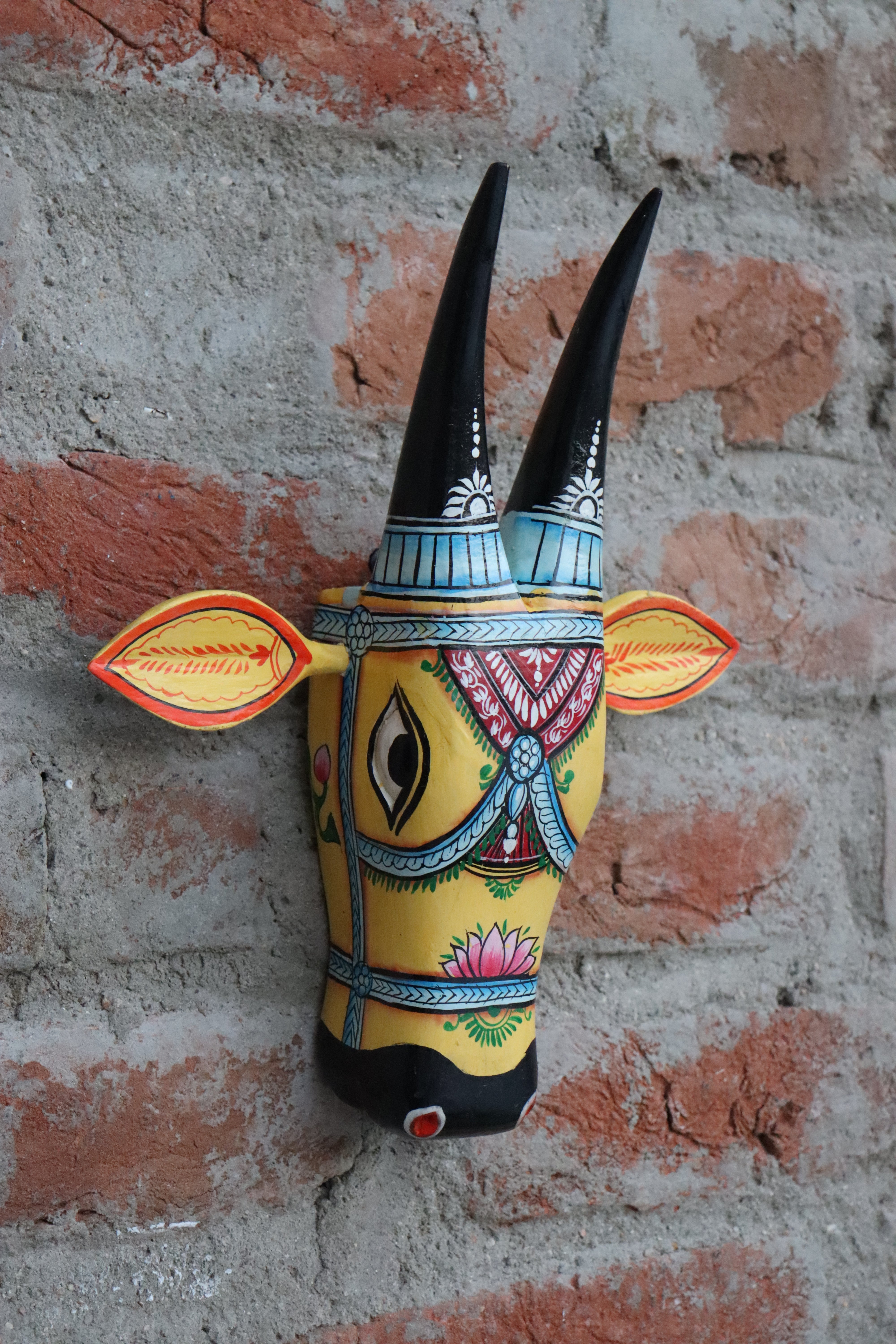 Traditional Indian folk art wooden cow bust, a colorful and decorative piece for wall hanging.