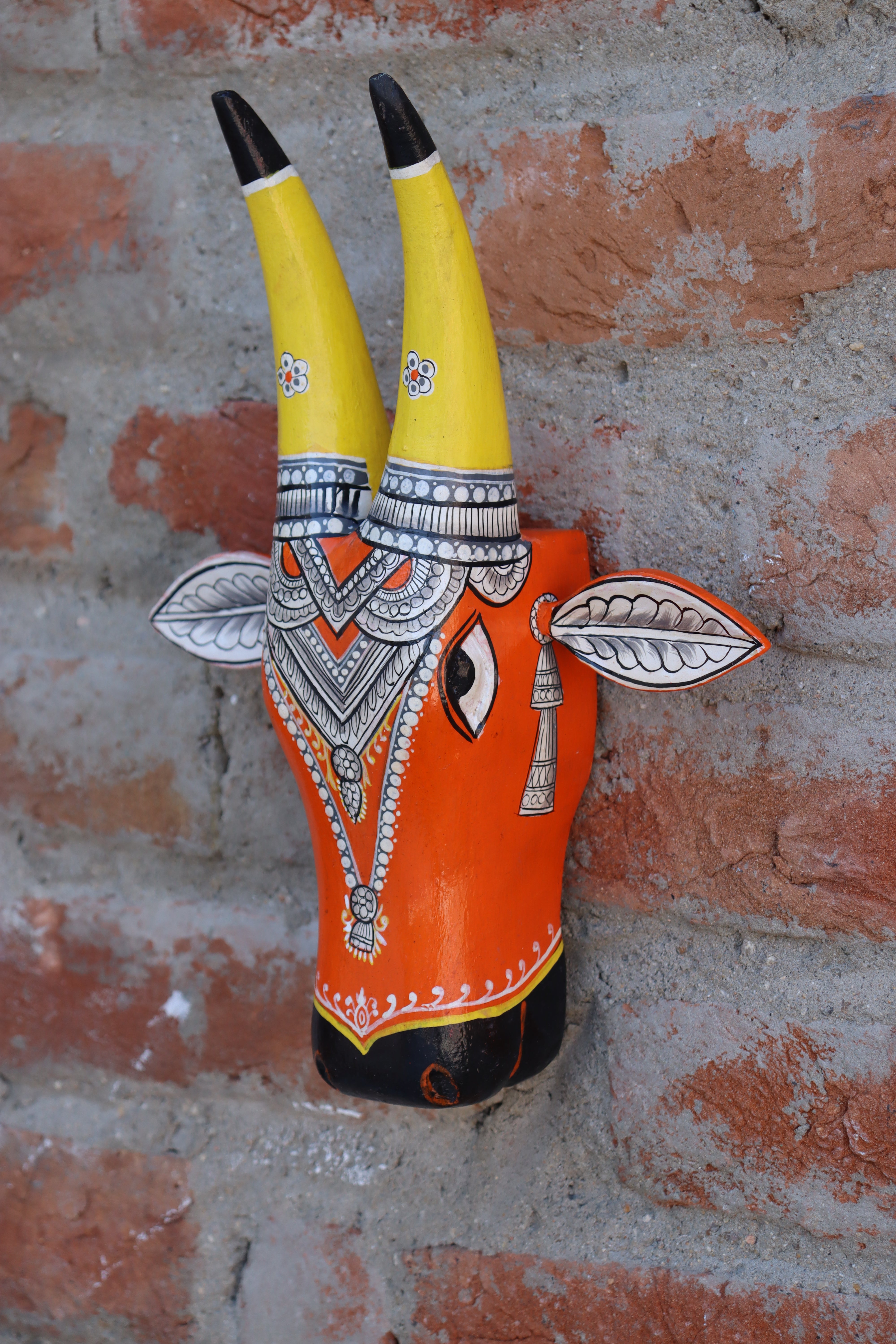 Traditional Indian folk art wooden bull head, a colorful and decorative piece for home accents.