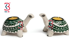 Two turtle-shaped candle holders with decorative patterns on a white background, featuring the KBart logo.
