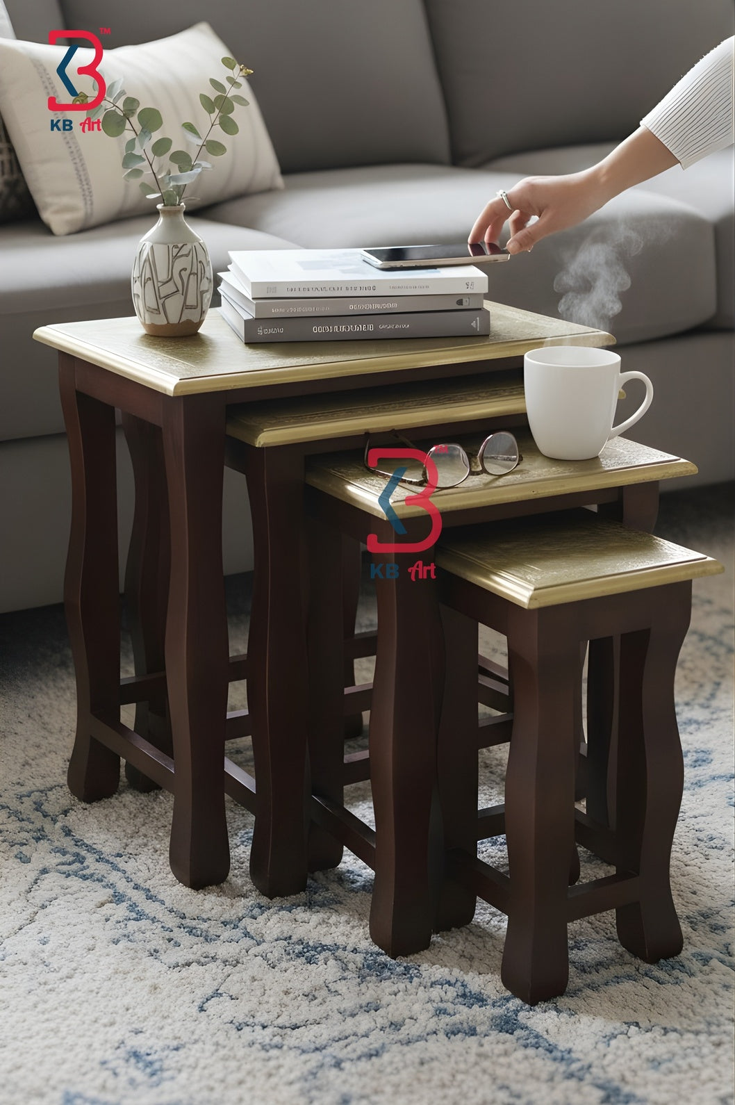 Three multi-size brass-fitted rectangular wooden side tables with curved legs arranged in a staggered step formation to highlight their graduating heights.