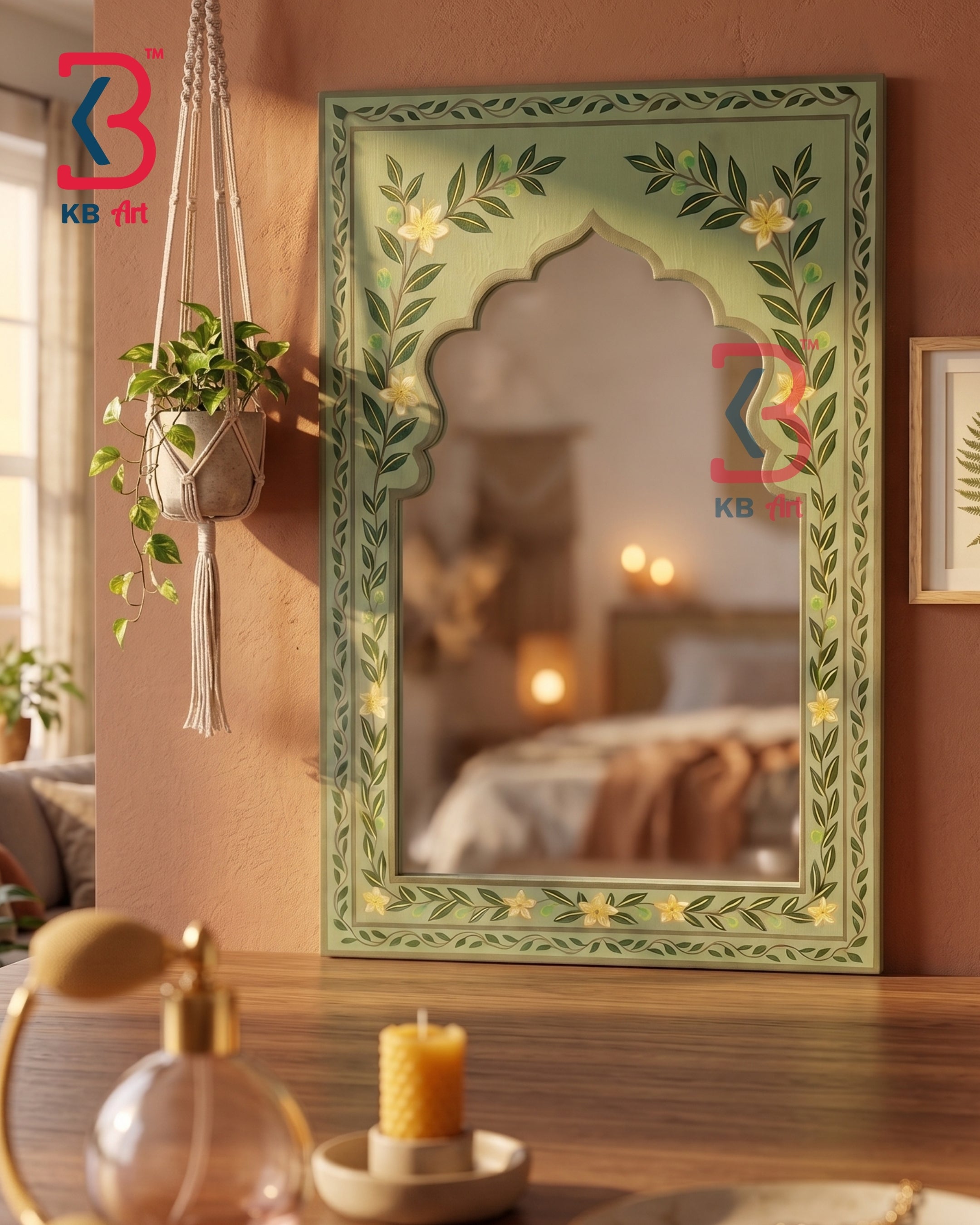 A decorative arched wall mirror with a hand-painted sage green floral frame, displayed on a wooden table in a warm, cozy room setting.