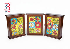 Three small wooden display cabinets with colorful hand-painted mosaic doors, shown on a plain white background. A KB Art logo is visible in the top-left corner.
