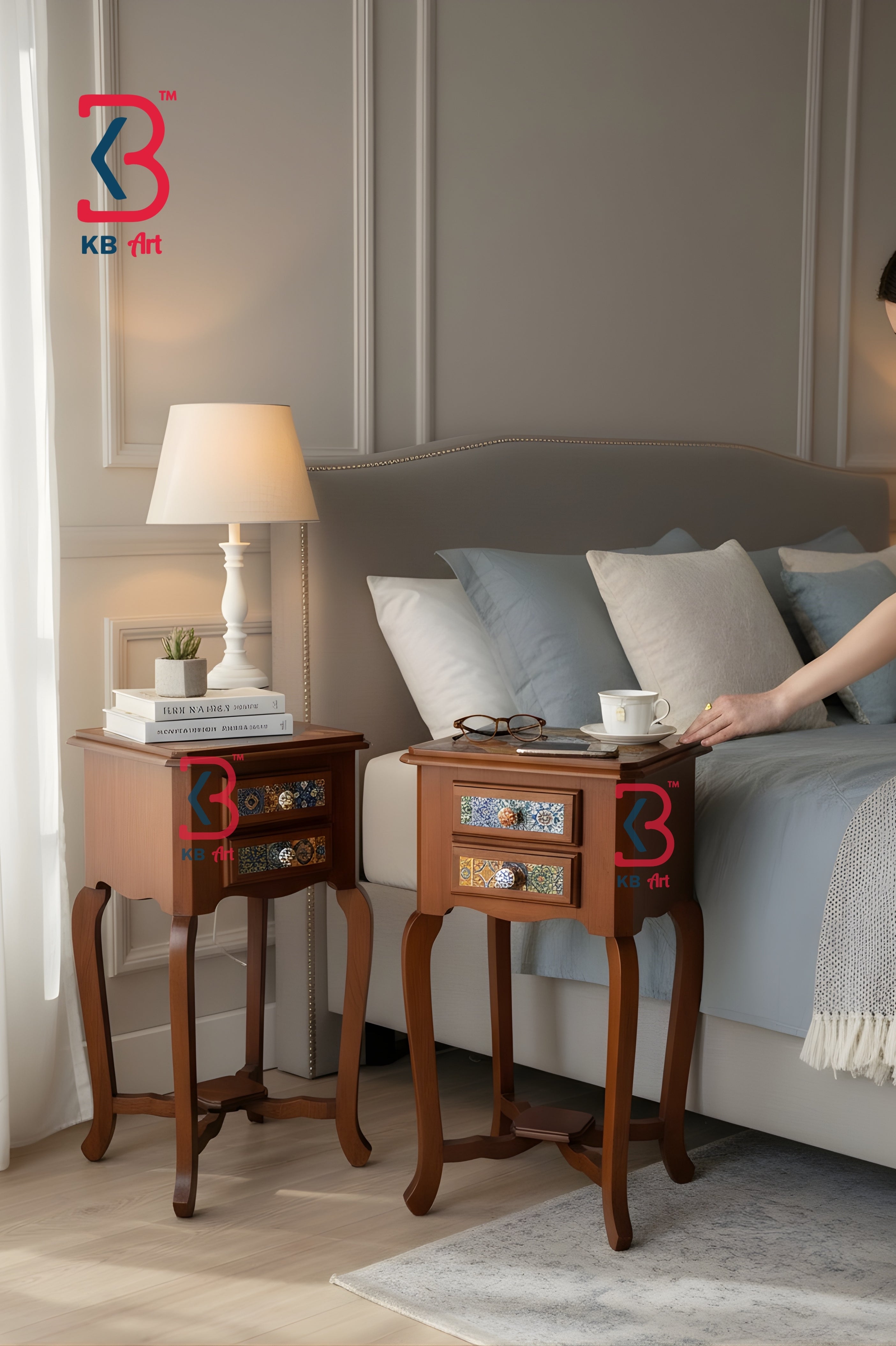 A bedroom scene showing two wooden nightstands beside a bed. One nightstand holds a white table lamp and books, while the other has a small tray and a hand reaching toward it.