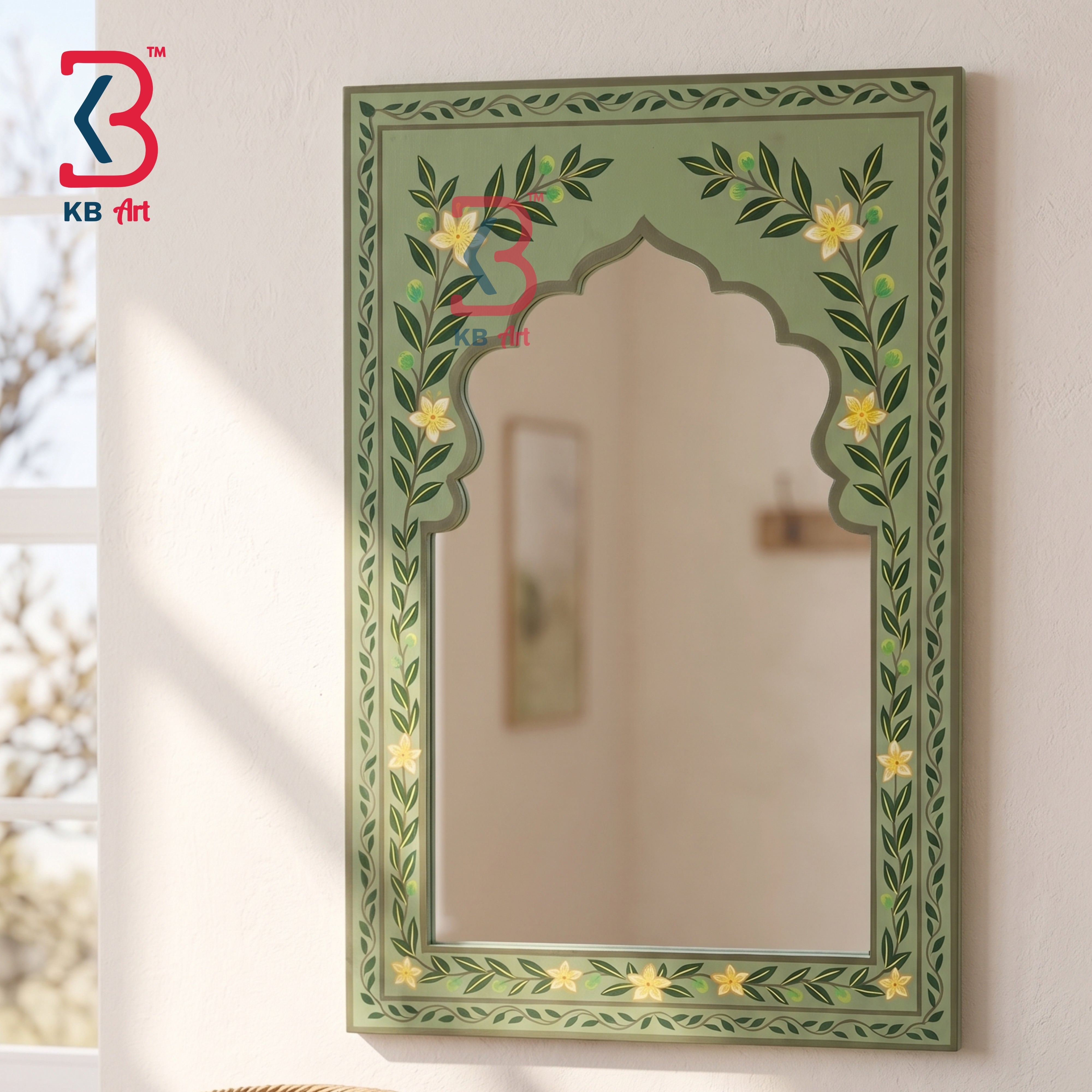 An ornate arched wall mirror with a sage green painted frame decorated with yellow flowers and green leafy vines, mounted on a light beige wall.