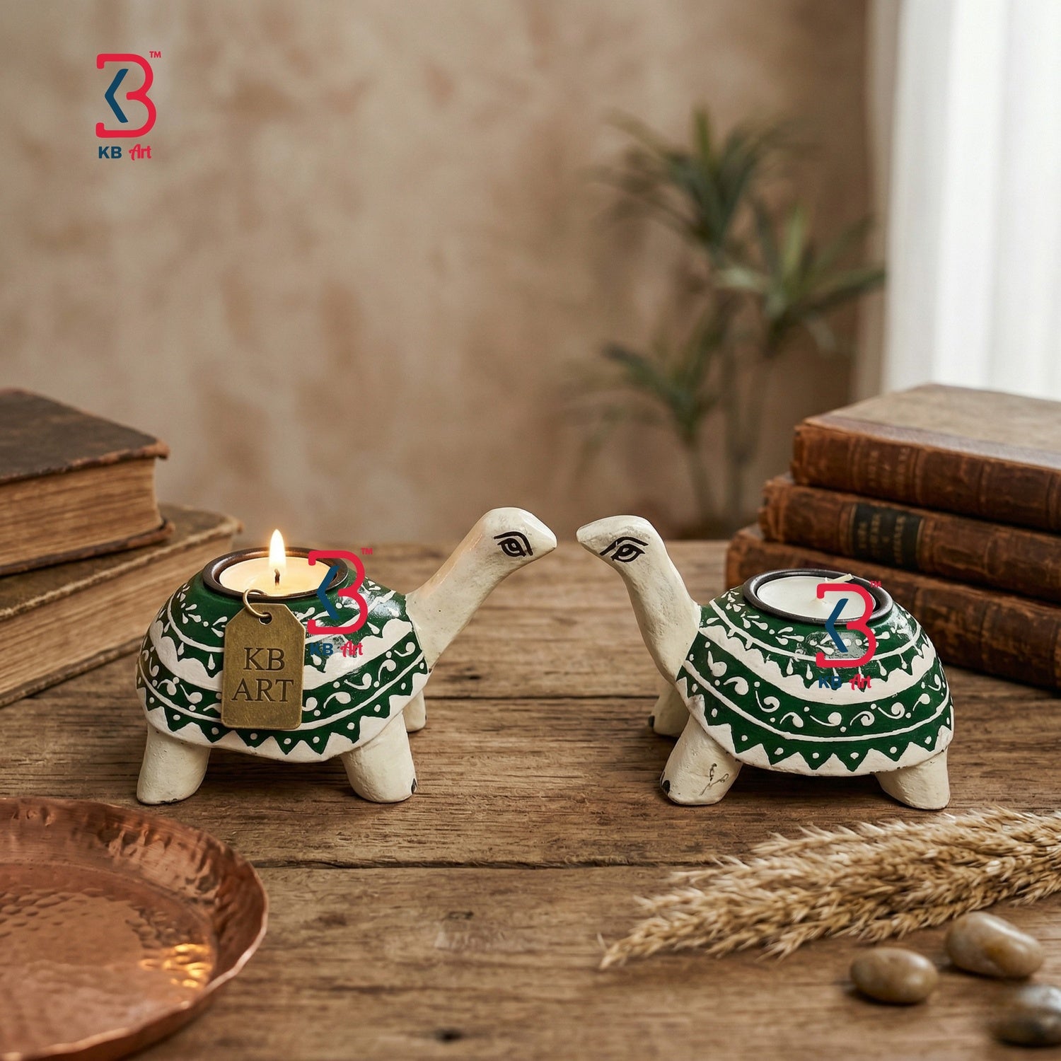 Two turtle-shaped candle holders with lit candles on a wooden surface, surrounded by books and plants. A styled lifestyle scene displaying the decorative hand-painted wooden tortoise stands glowing warmly on a festive living room table setup.