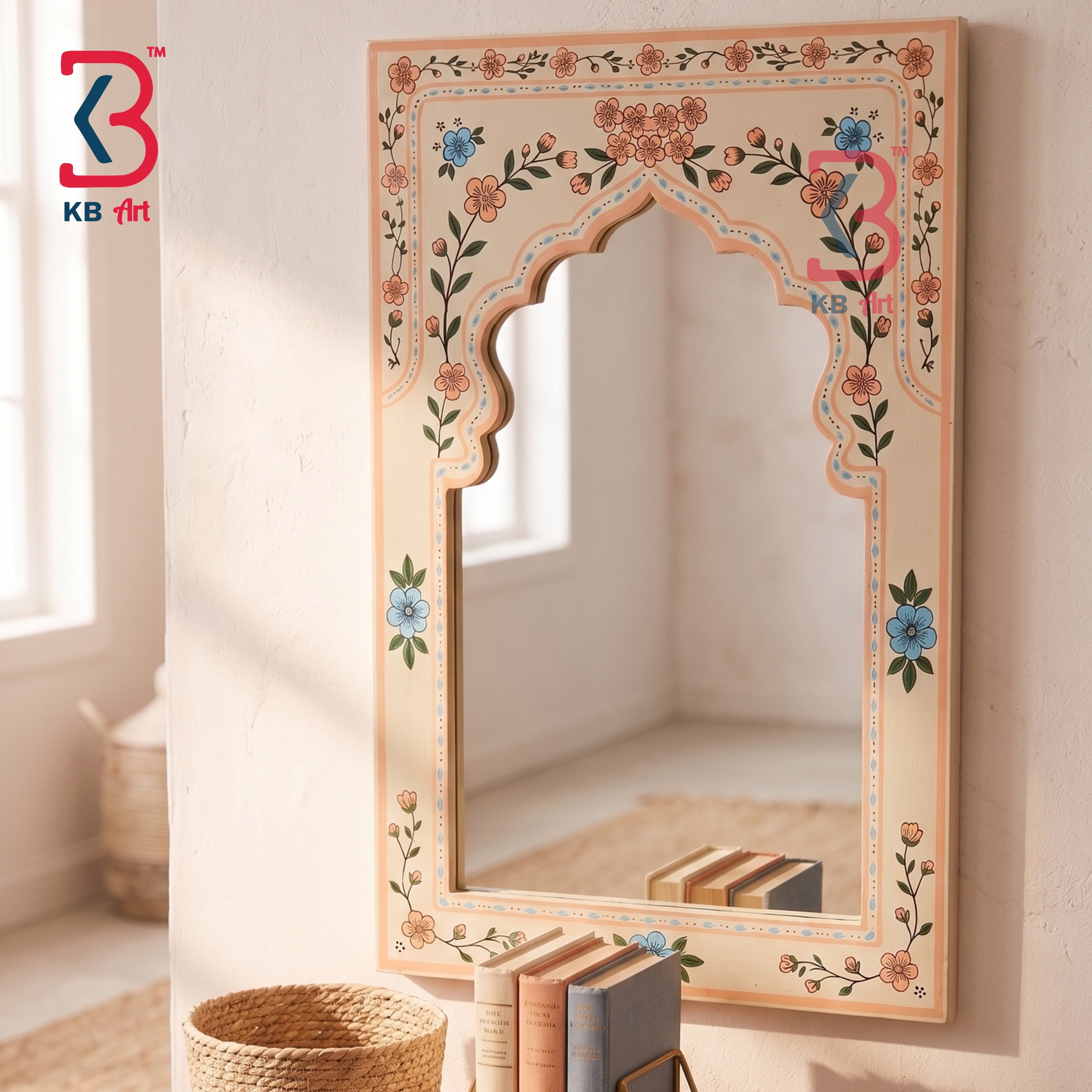 An ornate arched wall mirror with a beige frame decorated with hand-painted floral motifs in orange, blue, and green, shown in a brightly lit room.